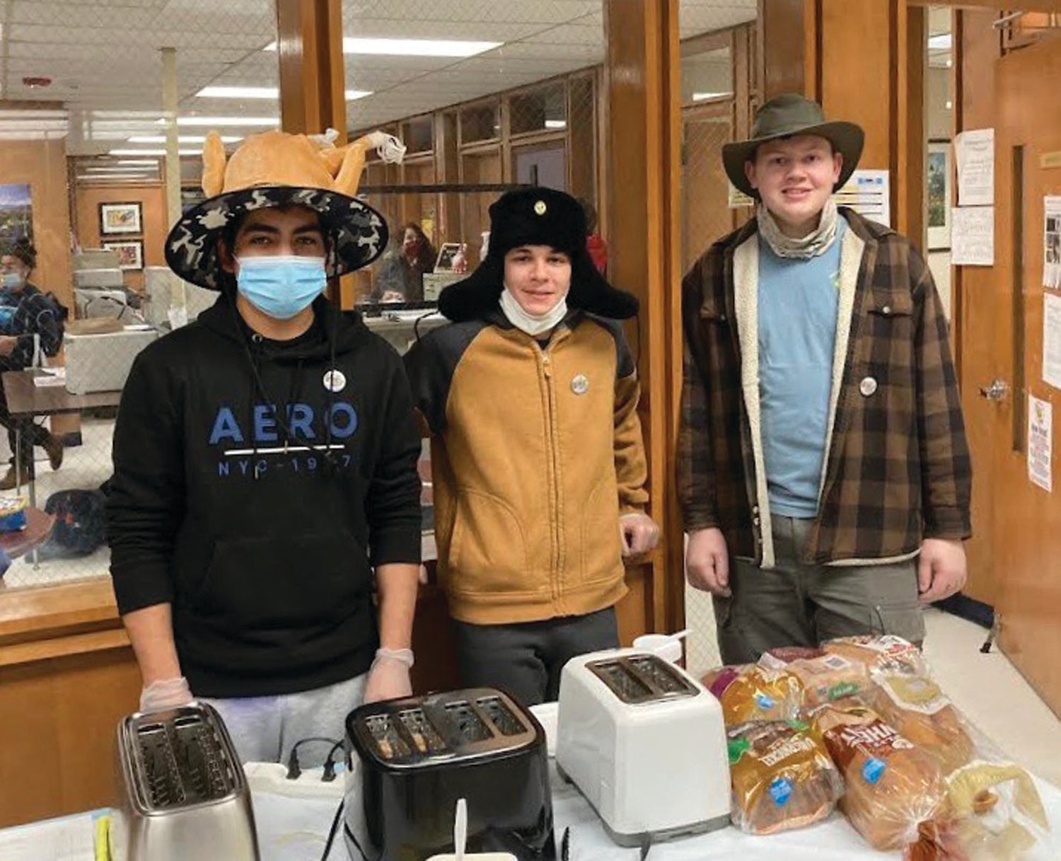 TOASTING TRIO: While swearing their Crazy Hats, JHS Music Students Josh Galeas, Willson El Hage and Domenic Whitten made toast for generous faculty and staff during the unique kick-off of the annual Rachel E. Carson Memorial Scholarship Fund.